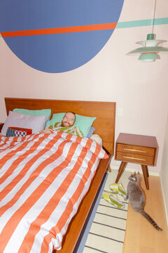 Laughing man in colorful bedroom