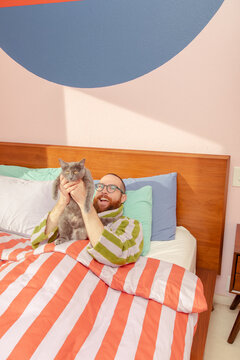 Man with cat in bed
