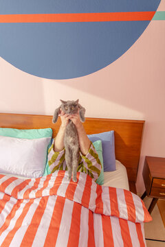 Man with cat in bed
