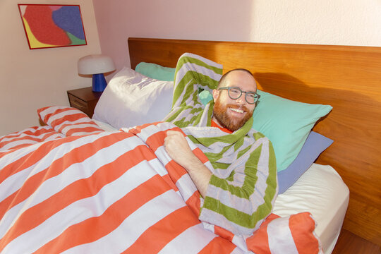 Man smiling in bed