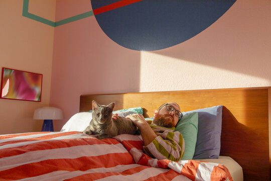 Man in bed with cat