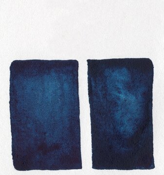 A textured, minimalist, rich blue box tied with a ribbon