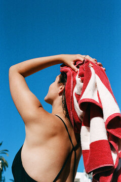 Woman Drying Hair Under Bright Summer Sky Film Photo