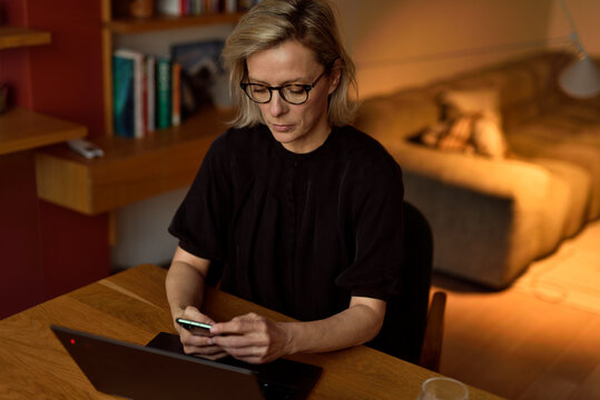 Concentrated Home Office Moment &mdash; Woman Texting on Phone