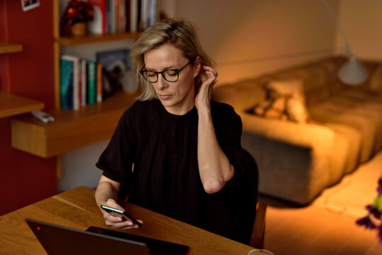 Home Office &mdash; Looking at Phone with Hand in Hair