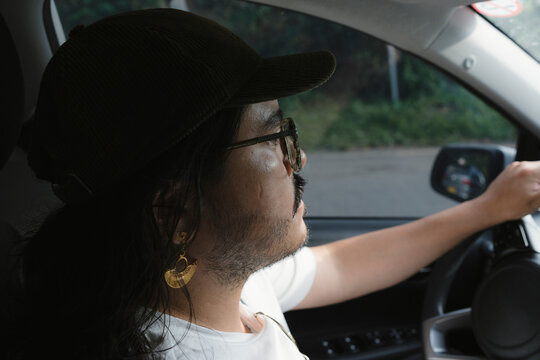 Person driving car on road trip journey