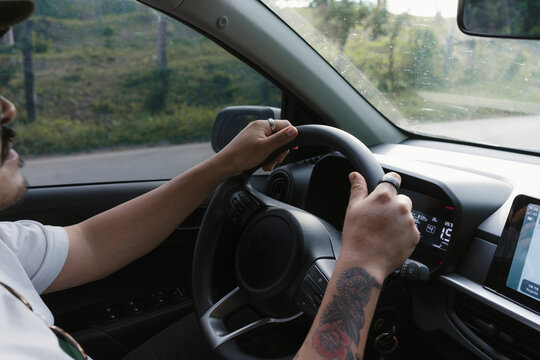 Man driving car on road trip journey