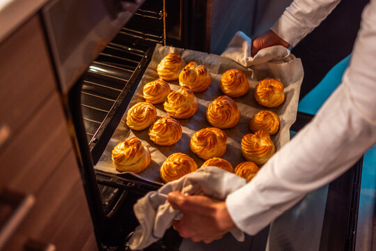 Removing Freshly Baked Cream Puffs