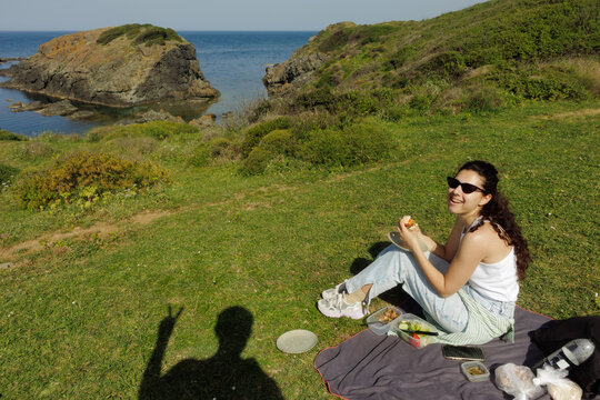 A young woman eats a burger