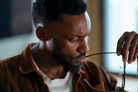 Man with glasses in thought
