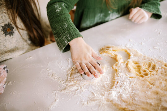A woman and a child are baking cookies.