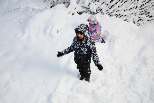Children Playing in Deep Fresh Snow During Winter Outdoor Fun