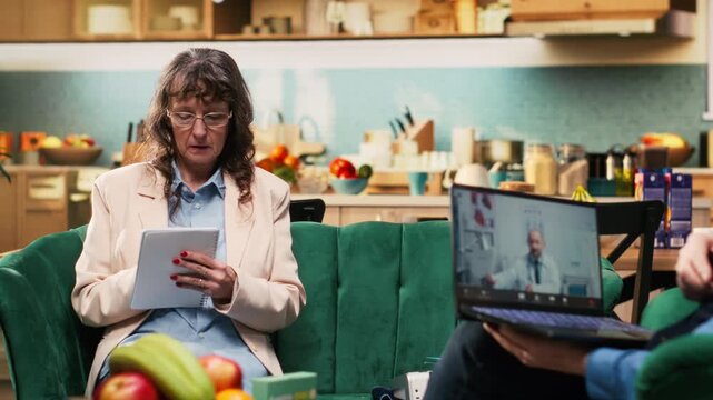 Retiree writing down medical recommendations during virtual call with medic, telehealth checkup discussion focuses on pills dosage and medicine, ensuring vitality at home. Taking notes.