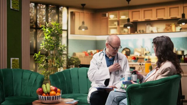 Doctor providing professional home care services for elderly woman during in-home medical checkup. Assisted living support includes preventive examination, vital signs monitoring, health safety.