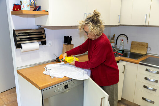 Applying stain remover to shirt