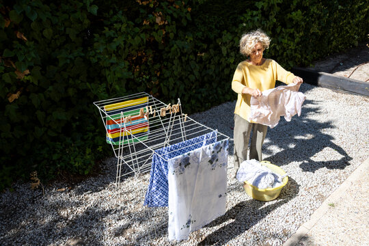 Hanging clothes on drying rack