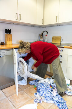 Woman loading laundry machine