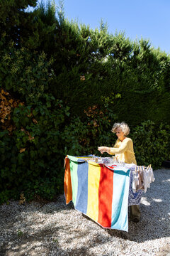 Woman hanging laundry in the sun