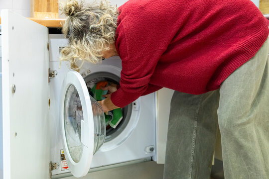 Placing clothes into washing machine