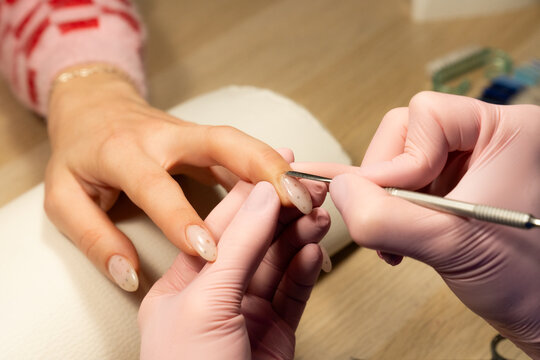 Nail care procedure at a salon with a client relaxing