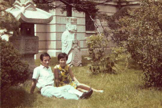 1970s Couple Resting Together at a Historic Park on a Summer Day