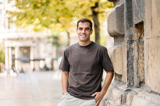 Smiling man standing outdoors in city street