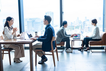 オフィスで商談・打ち合わせを行うビジネスパーソンたち