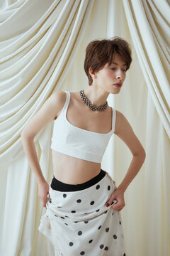 Fashion Portrait Woman in White Top and Polka Dot Skirt 