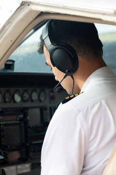 Pilot sitting in Cockpit of single engine turboprop aircraft.