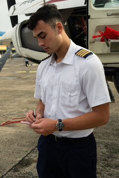 Pilot completing paperwork on apron