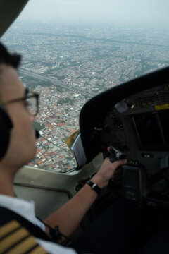 Cockpit view over urban landscape during flight