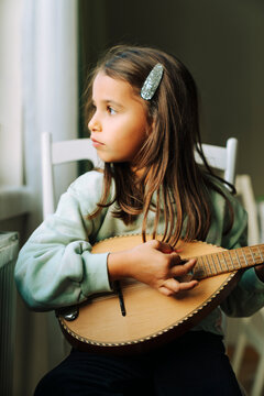 Little girl playing a mandolin