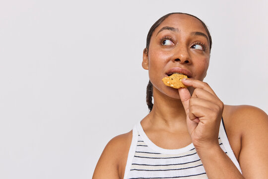 Woman in studio eating a cookie