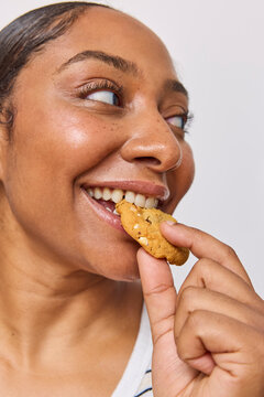 Woman in studio eating a cookie