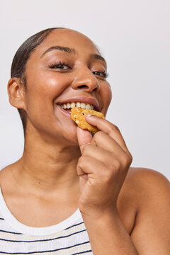 Woman in studio eating a cookie