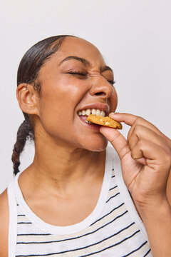 Woman in studio eating a cookie