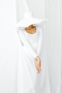 Woman wearing wide brim  hat in studio