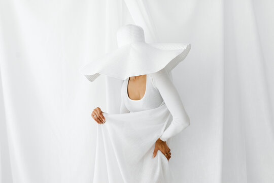 Woman wearing large white hat 