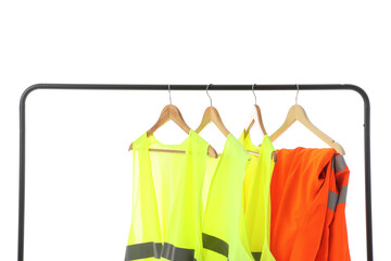 Rack with reflective worker's uniform on white background