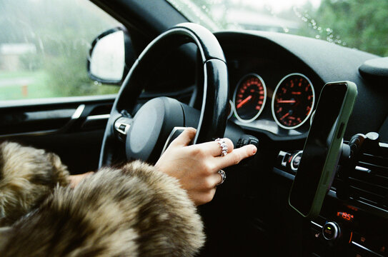 Driver Hands on Steering Wheel in Rain
