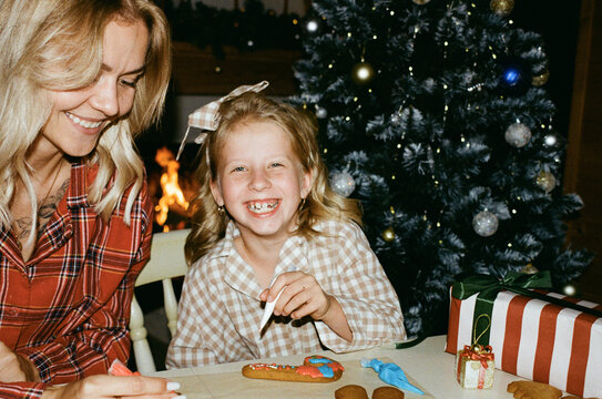 Mother and Daughter Decorating Gingerbread Cookies
