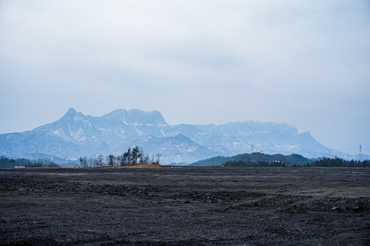 Barren Plain Against Snow-Capped Alpine Mountains
