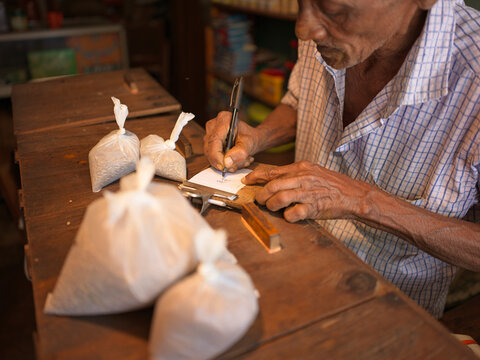 Hand written bill being prepared in spice shop