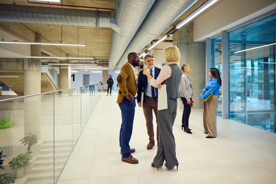 Corporate workers talk to each other