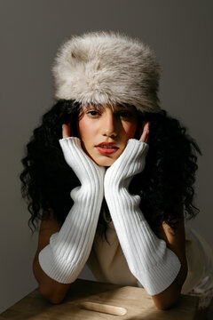 Woman wearing fur hat and white arm warmers