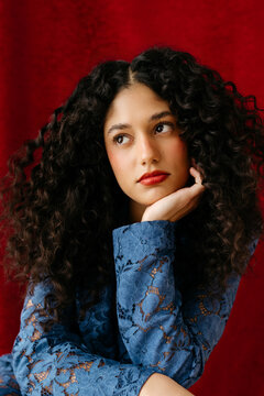 Thoughtful young woman with curly hair 
