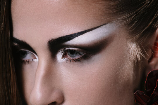 Model Showcases Artistic Makeup With Bold Features in Studio