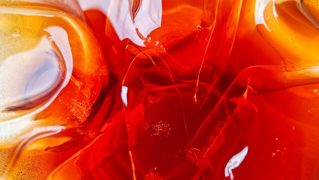 Abstract Macro Shot of Iced Tea with Refracted Amber Light and Ice Cubes