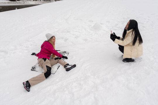 Friends Enjoying Snow Play in Winter Landscape During Daytime
