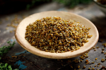 Buckwheat Groats in Wooden Bowl on Dark Rustic Surface